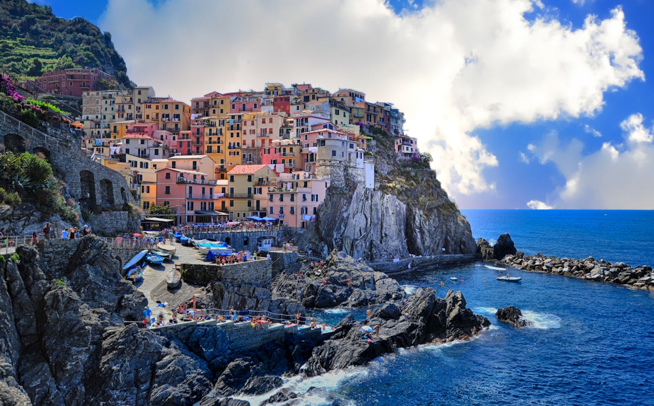 Assorted-color Houses Beside Body of Water